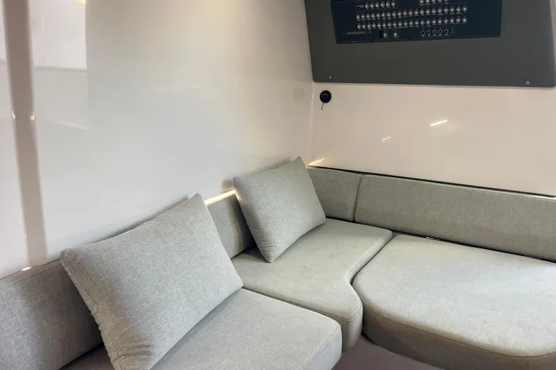 Sweet Spot Yacht Photos Pics Interior of 2021 Axopar 37 Cross Cabin with gray seating and control panel.
