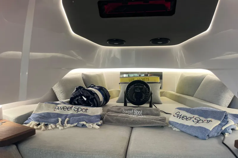 Sweet Spot Yacht Photos Pics Interior of 2021 Axopar 37 Cross Cabin with cozy seating and "Sweet Spot" towels.