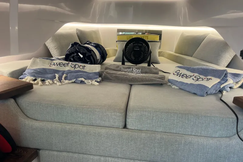 Sweet Spot Yacht Photos Pics Luxurious interior of 2021 Axopar 37 Cross Cabin with cozy seating and decorative pillows.