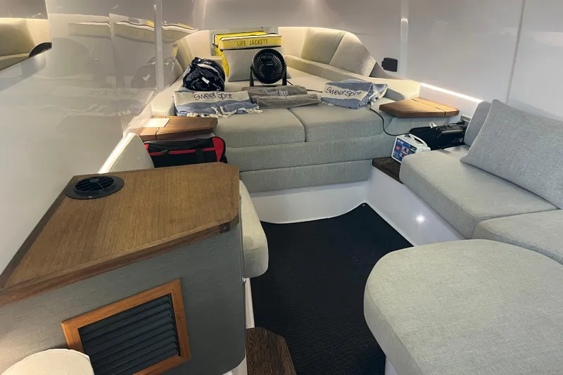 Sweet Spot Yacht Photos Pics Interior of 2021 Axopar 37 Cross Cabin with cozy seating and nautical decor.