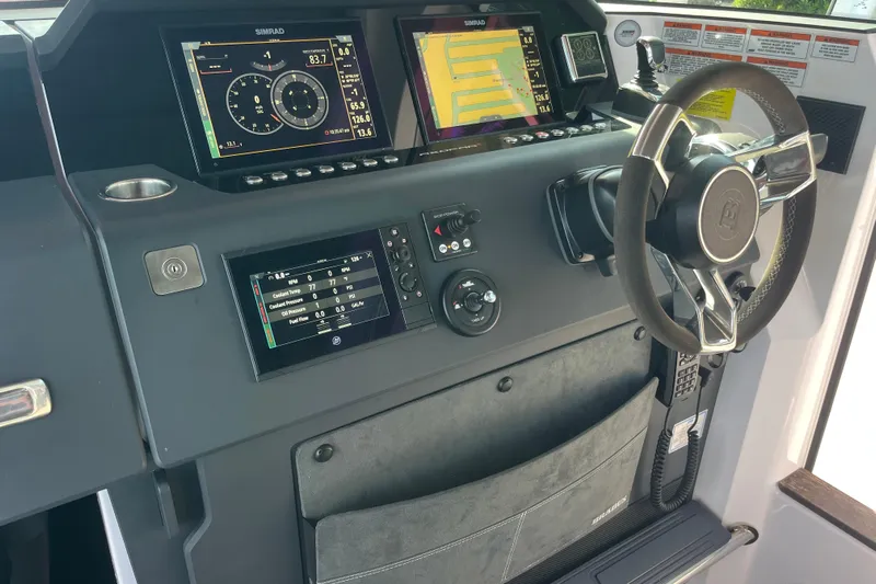 Sweet Spot Yacht Photos Pics 2021 Axopar 37 Cross Cabin dashboard with Simrad displays and modern steering wheel.