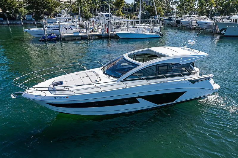  Yacht Photos Pics 2022 Beneteau Gran Turismo 45 luxury yacht cruising in a marina.