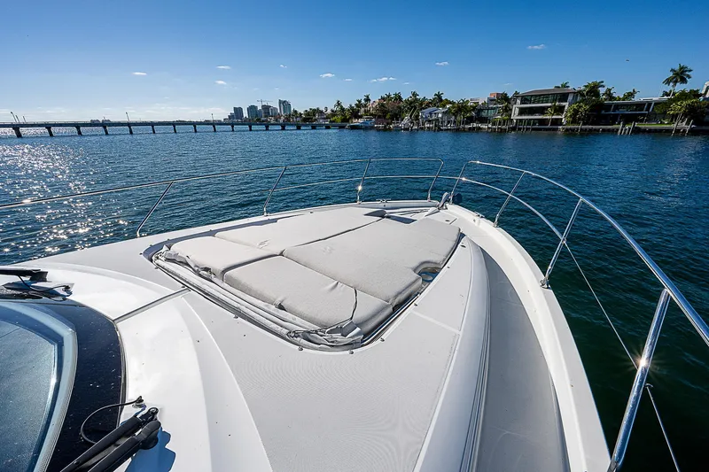  Yacht Photos Pics 2022 Beneteau Gran Turismo 45 yacht bow with sunpad, cruising on a sunny day.