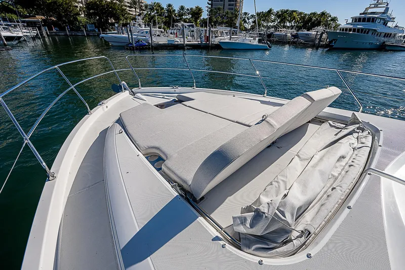  Yacht Photos Pics 2022 Beneteau Gran Turismo 45 yacht with sunbathing area at the bow, docked in a marina.