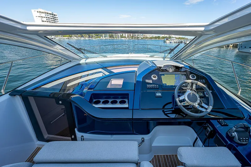  Yacht Photos Pics 2022 Beneteau Gran Turismo 45 yacht helm station with waterfront view.