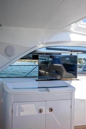  Yacht Photos Pics 2022 Beneteau Gran Turismo 45 yacht interior with TV and storage cabinet.