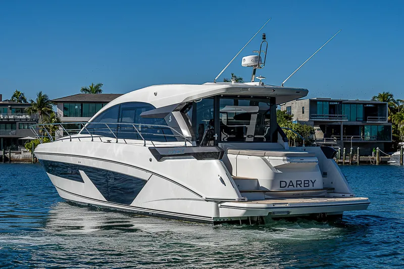  Yacht Photos Pics Beneteau Gran Turismo 45 yacht, 2022, on calm water near modern homes.