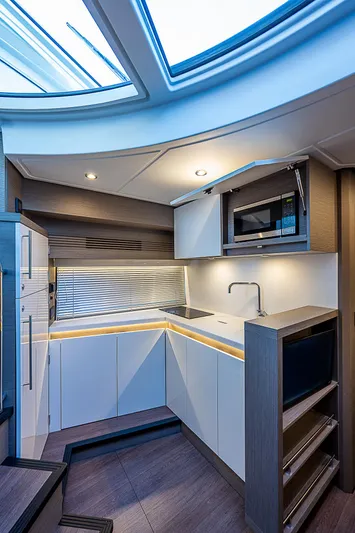 Yacht Photos Pics Modern kitchen interior of 2022 Beneteau Gran Turismo 45 yacht with skylight.