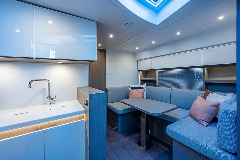  Yacht Photos Pics Interior of 2022 Beneteau Gran Turismo 45 yacht with modern kitchen and cozy seating area.
