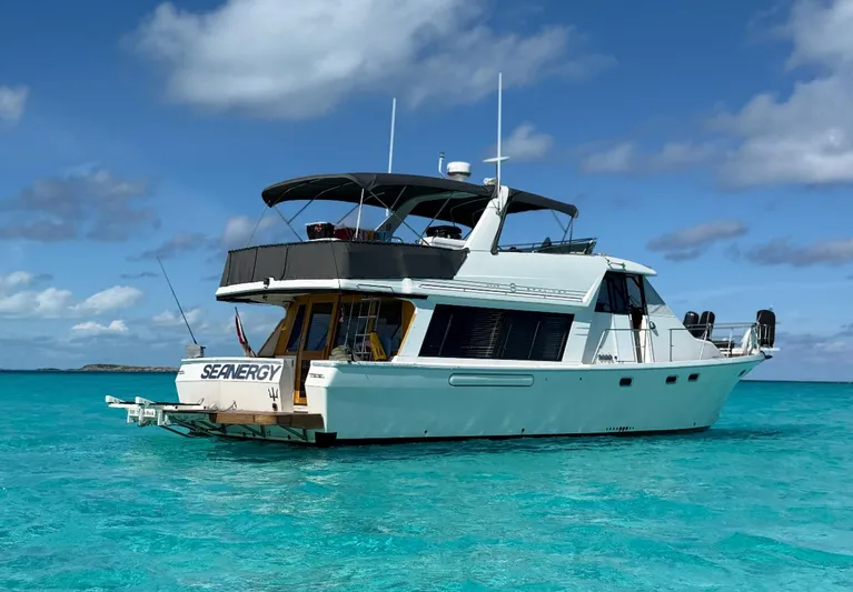 Seanergy III Yacht Photos Pics 1995 Bayliner 4788 Pilothouse Motoryacht on turquoise water under blue sky.