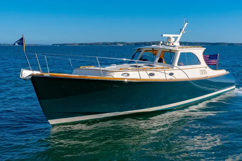 Charmer Yacht Photos Pics 1999 Hinckley Talaria 44 Express yacht cruising on open water.