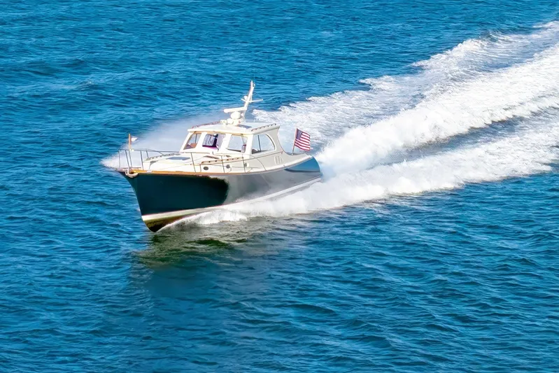 Charmer Yacht Photos Pics 1999 Hinckley Talaria 44 Express cruising on open blue water.