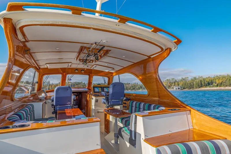 Charmer Yacht Photos Pics 1999 Hinckley Talaria 44 Express yacht interior with polished wood and striped seating.