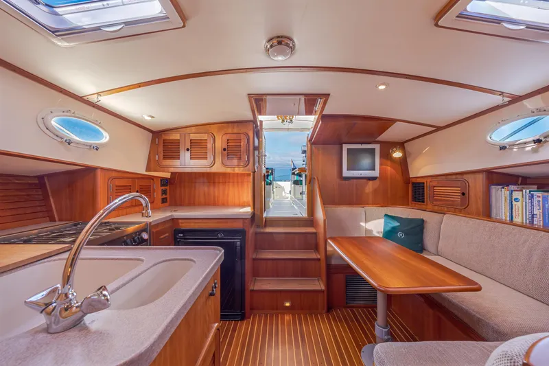 Charmer Yacht Photos Pics Luxurious 1999 Hinckley Talaria 44 Express yacht interior with wood finish and cozy seating.