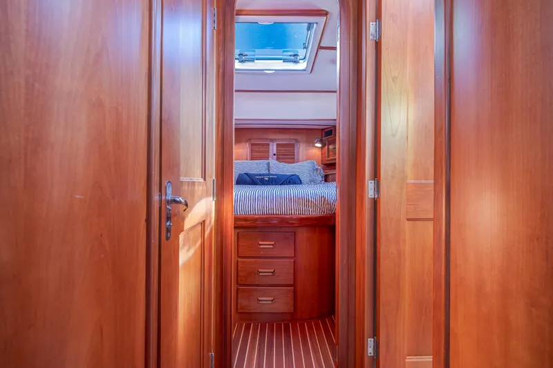 Charmer Yacht Photos Pics Interior of 1999 Hinckley Talaria 44 Express, featuring wooden cabinetry and cozy sleeping quarters.