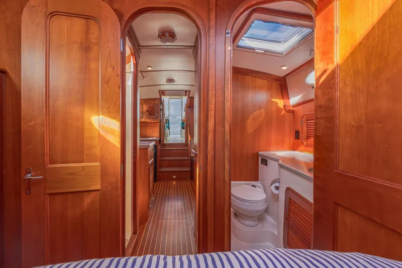 Charmer Yacht Photos Pics Interior of 1999 Hinckley Talaria 44 Express yacht with wooden finish and bathroom.