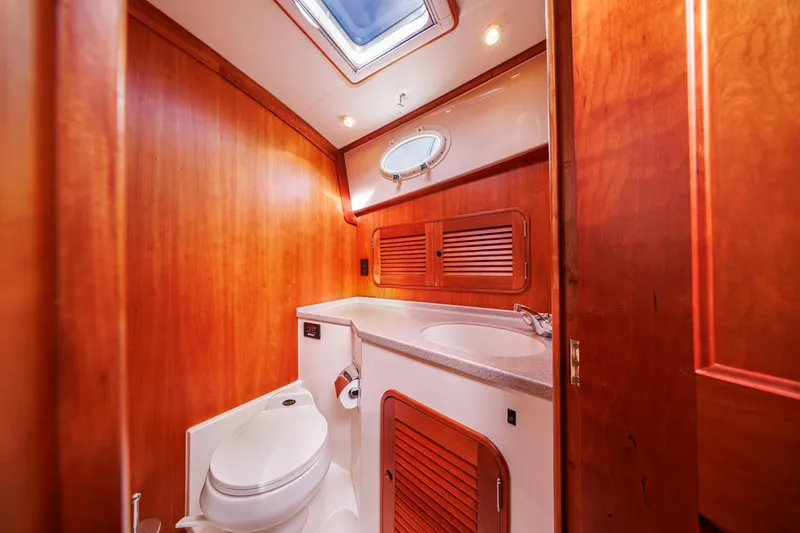 Charmer Yacht Photos Pics Luxurious wooden bathroom interior of 1999 Hinckley Talaria 44 Express yacht.