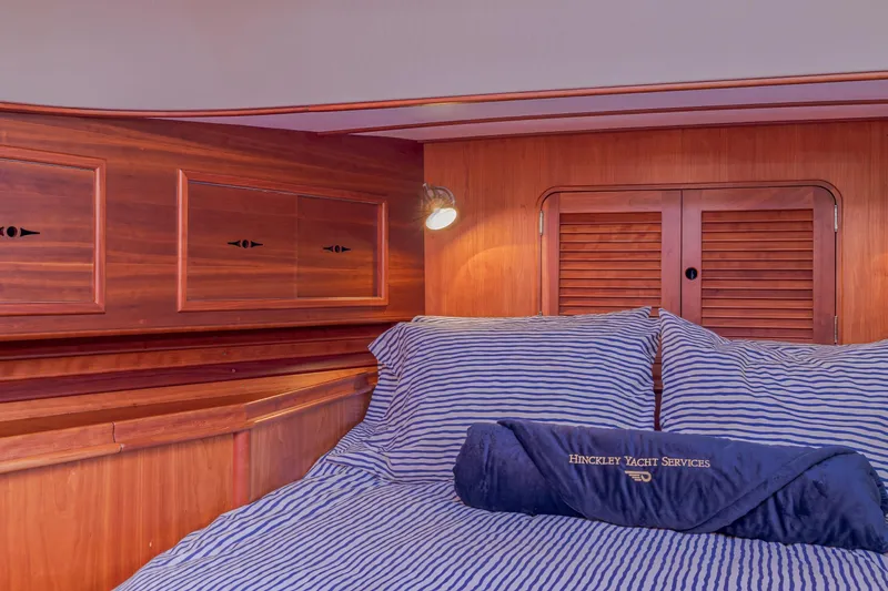 Charmer Yacht Photos Pics Interior cabin of 1999 Hinckley Talaria 44 Express yacht with striped bedding.
