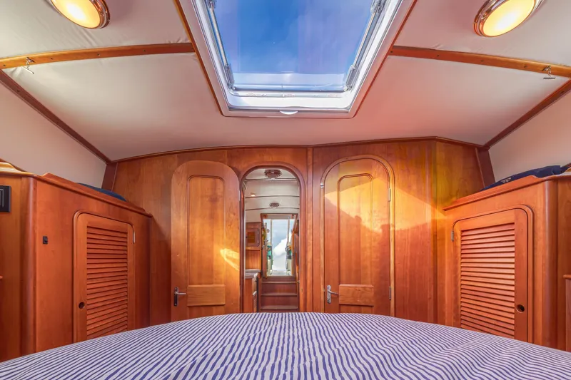 Charmer Yacht Photos Pics Interior of 1999 Hinckley Talaria 44 Express yacht with wooden cabinetry and skylight.