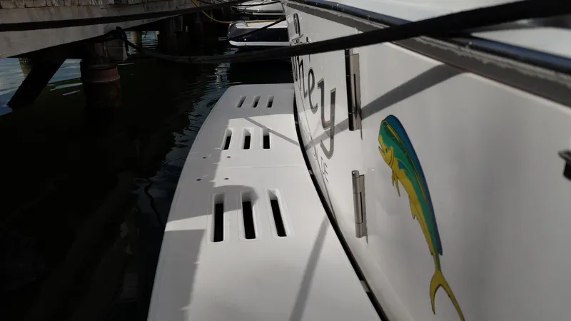 Siboney Yacht Photos Pics Cabo 40 Express 2004 at dock with fish graphic.