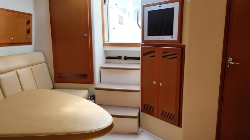 Siboney Yacht Photos Pics Interior of 2004 Cabo 40 Express with seating and TV.