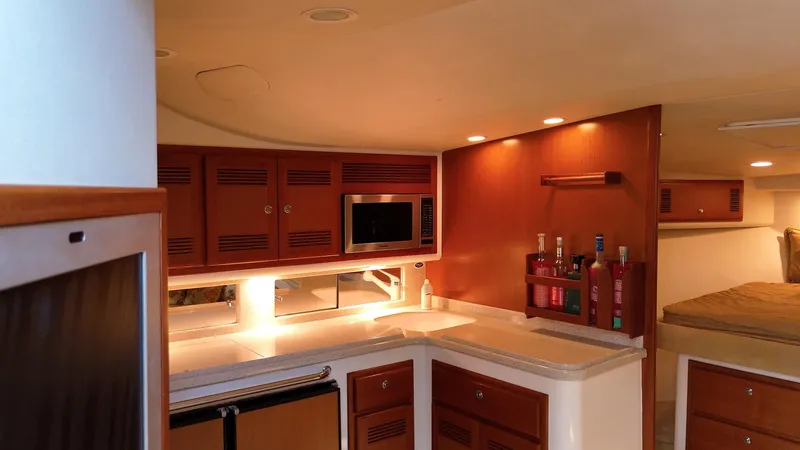 Siboney Yacht Photos Pics Interior of 2004 Cabo 40 Express with kitchen and sleeping area.