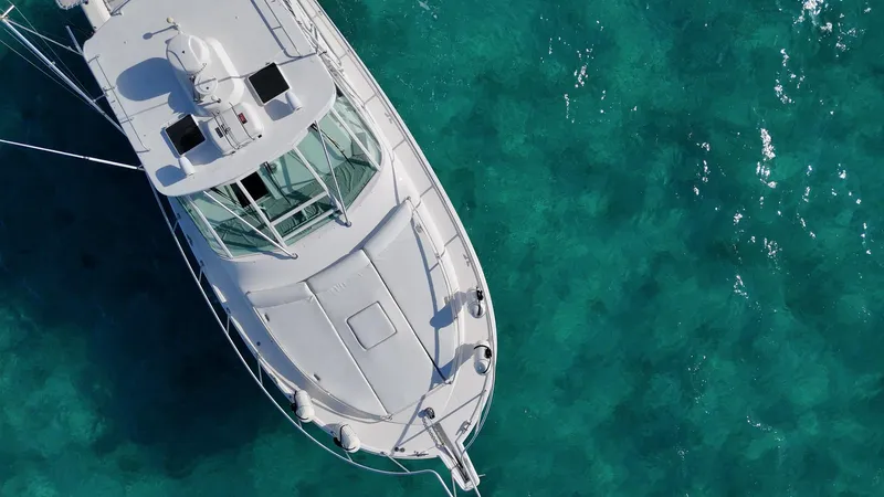 Siboney Yacht Photos Pics Aerial view of a Cabo 40 Express yacht on turquoise water.