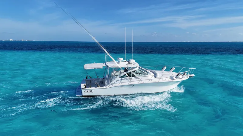 Siboney Yacht Photos Pics 2004 Cabo 40 Express yacht cruising on turquoise sea.