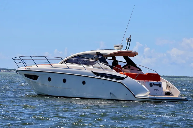  Yacht Photos Pics 2014 Azimut 38 yacht cruising on open water under a clear blue sky.