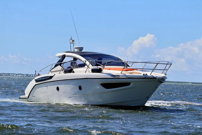  Yacht Photos Pics 2014 Azimut 38 yacht cruising on open water under clear blue skies.