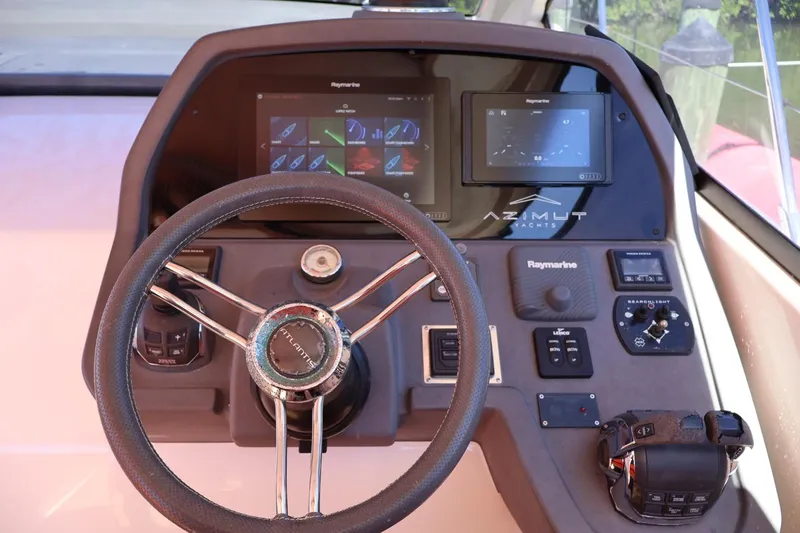  Yacht Photos Pics Cockpit of 2014 Azimut 38 yacht with Raymarine navigation system and steering wheel.