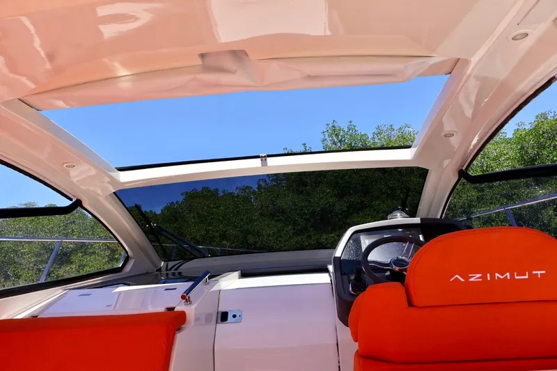  Yacht Photos Pics Interior view of 2014 Azimut 38 yacht cockpit with red seats and open sunroof.