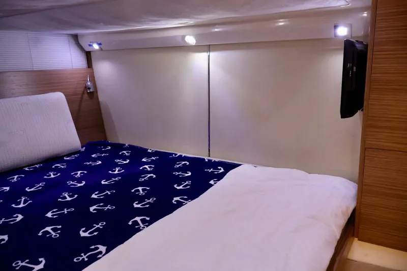  Yacht Photos Pics Cozy bedroom interior of 2014 Azimut 38 yacht with anchor-themed bedding.