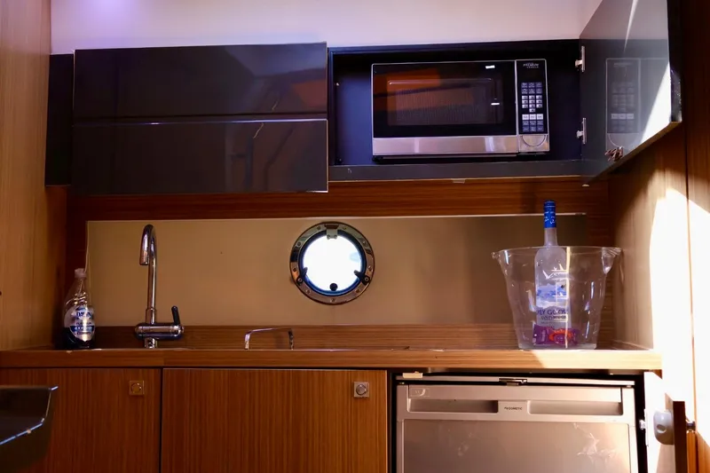  Yacht Photos Pics Compact kitchen area in a 2014 Azimut 38 yacht with microwave and sink.