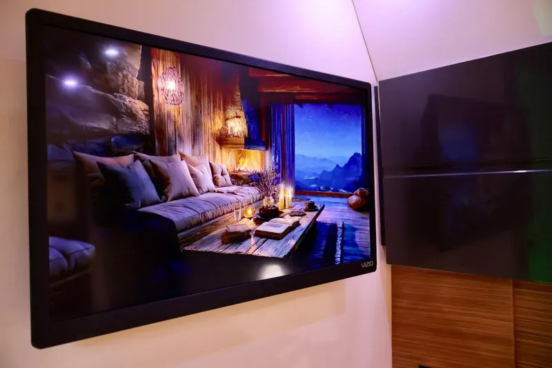  Yacht Photos Pics Flat-screen TV displaying cozy living room scene on Azimut 38 yacht, 2014 model.