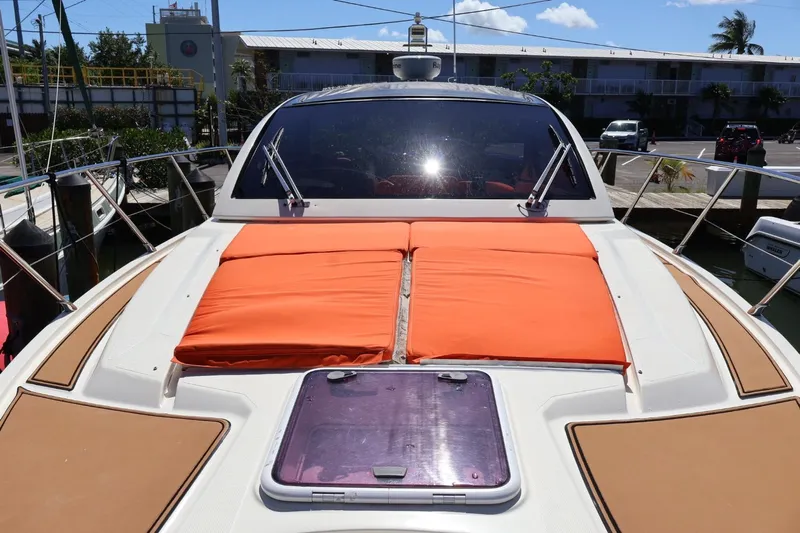  Yacht Photos Pics 2014 Azimut 38 yacht with orange sun pads docked in a marina.