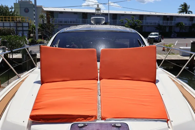  Yacht Photos Pics 2014 Azimut 38 yacht with orange sun loungers on deck, docked at marina.