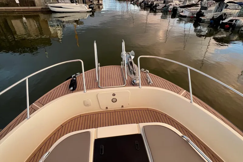  Yacht Photos Pics Bow view of 2024 Targa 41 boat with teak deck in marina setting.