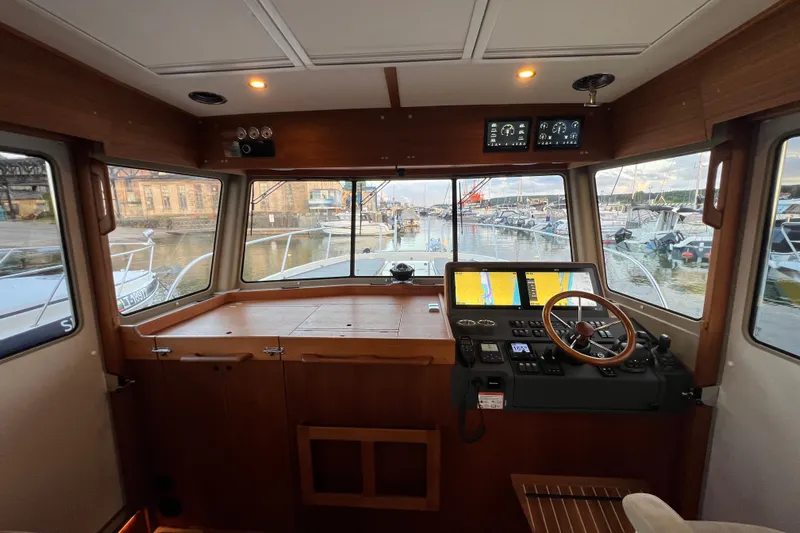  Yacht Photos Pics 2024 Targa 41 boat interior with modern navigation controls and panoramic marina view.