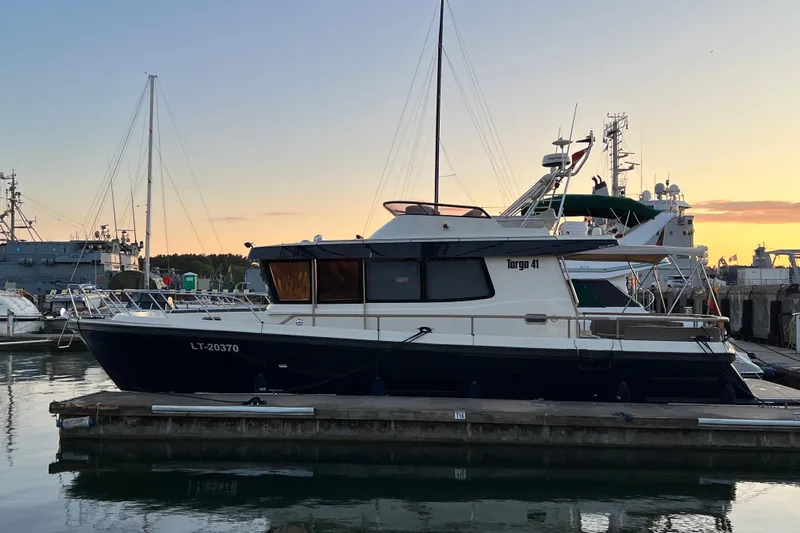  Yacht Photos Pics 2024 Targa 41 boat docked at sunset, showcasing sleek design and modern features.