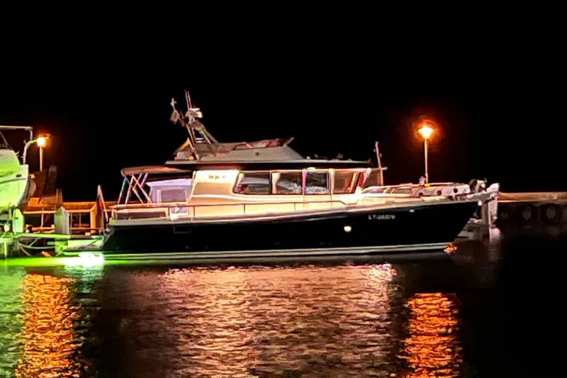  Yacht Photos Pics 2024 Targa 41 boat docked at night, illuminated by dock lights.