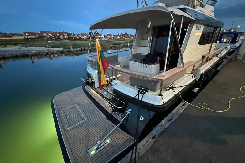  Yacht Photos Pics 2024 Targa 41 yacht docked at marina, evening view with illuminated water.