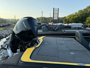2025 Triton 20XP Patriot boat with Mercury engine, parked outdoors.