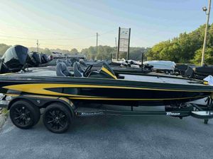 2025 Triton 20XP Patriot boat in black and yellow on trailer, parked outdoors.