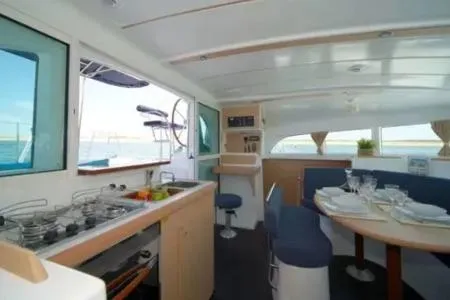 Arcane Yacht Photos Pics Interior of 2016 Lagoon 380 catamaran with kitchen and dining area.