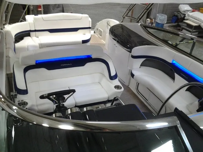 Lucky Yacht Photos Pics Interior of a 2018 Formula 370 Super Sport boat with blue lighting.