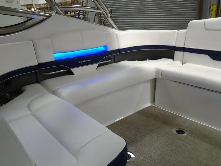 Lucky Yacht Photos Pics Interior of a 2018 Formula 370 Super Sport boat with blue lighting.