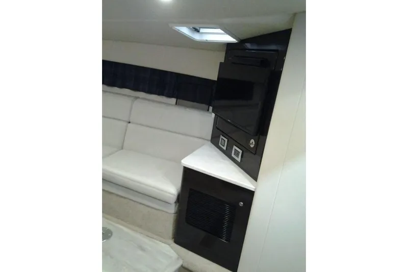 Lucky Yacht Photos Pics Interior of a 2018 Formula 370 Super Sport yacht with sofa and TV.