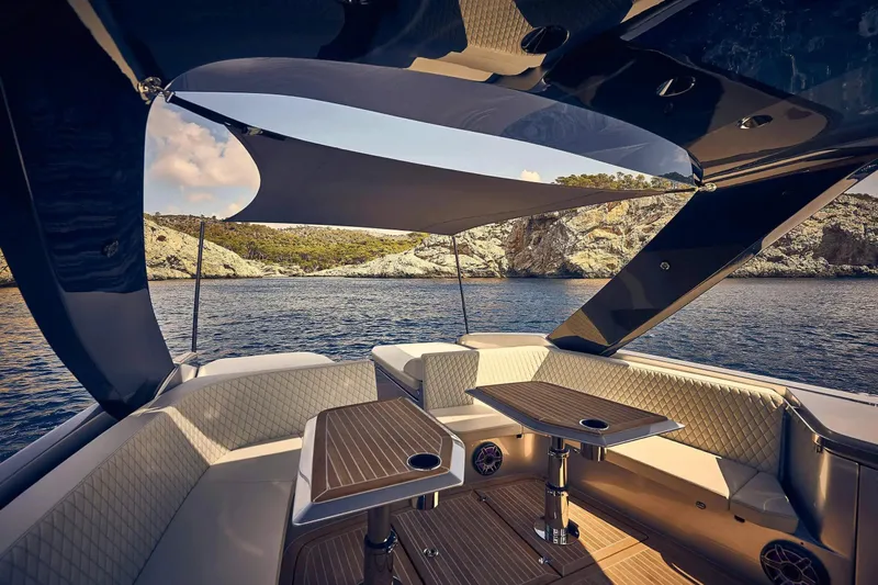  Yacht Photos Pics Luxurious 2023 Frauscher 1414 Demon yacht interior with elegant seating and scenic ocean view.
