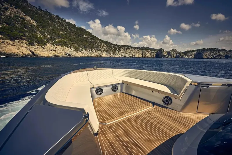  Yacht Photos Pics Luxurious 2023 Frauscher 1414 Demon yacht with elegant seating, cruising near scenic coastline.